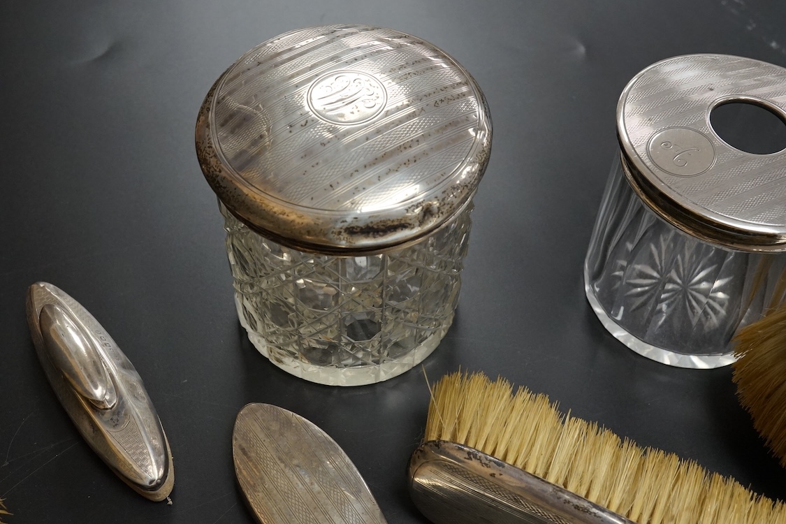 Ten assorted silver mounted dressing table items, including brushes, hand mirror, manicure items and glove stretchers.